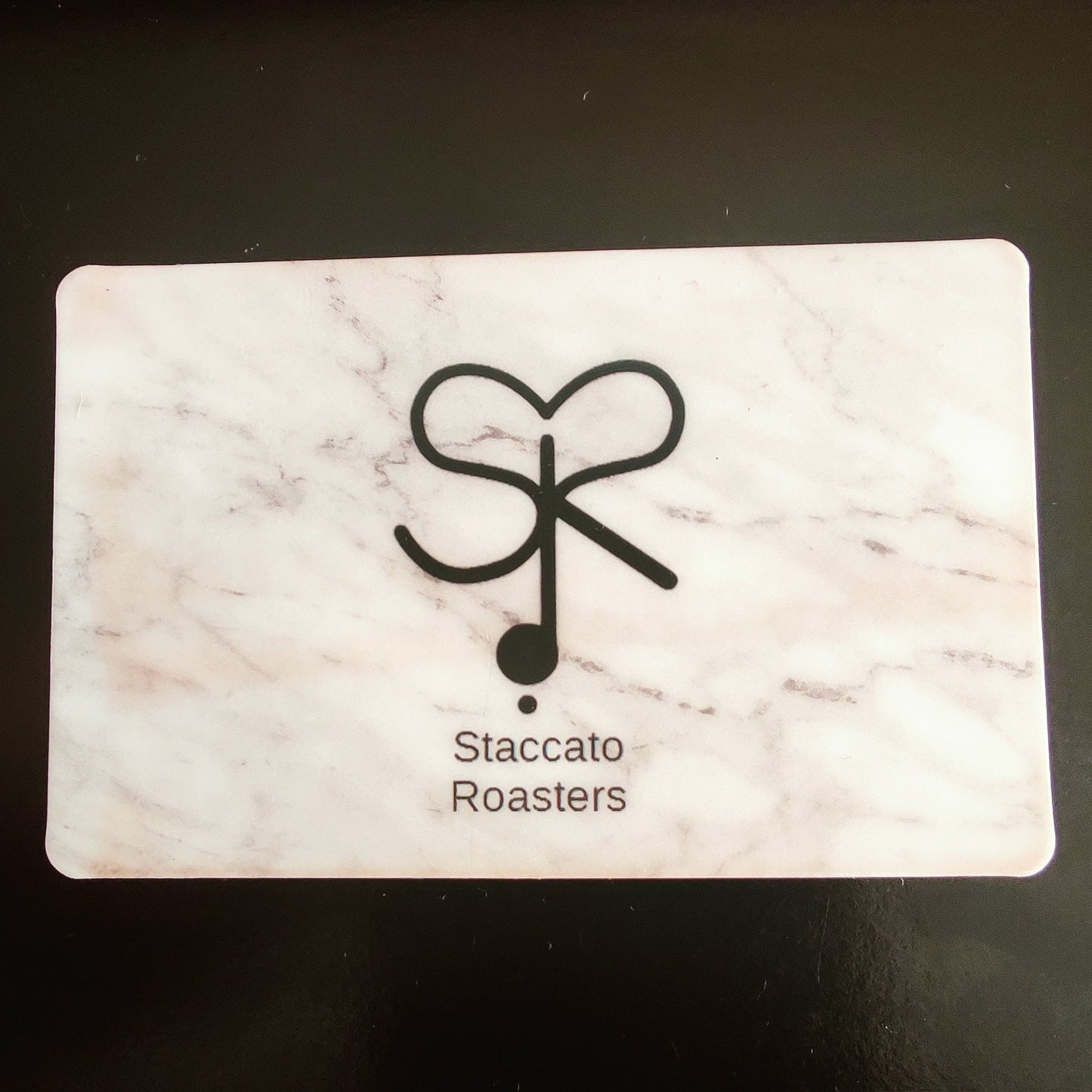 Card with Staccato Roasters logo on a marble patterned background