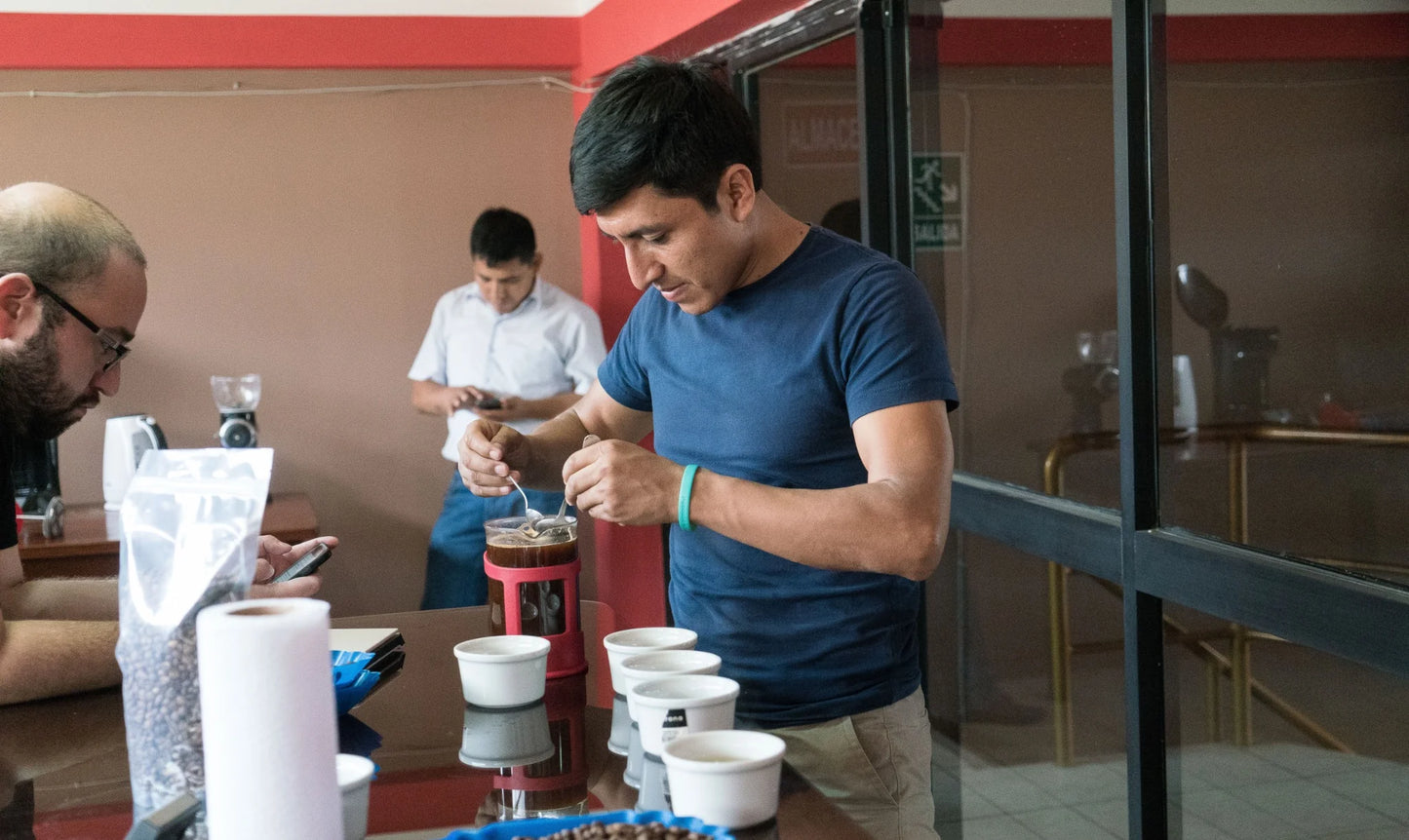 Rony Lavan evaluating freshly brewed coffee during a cupping session at Lima Coffee in Peru.