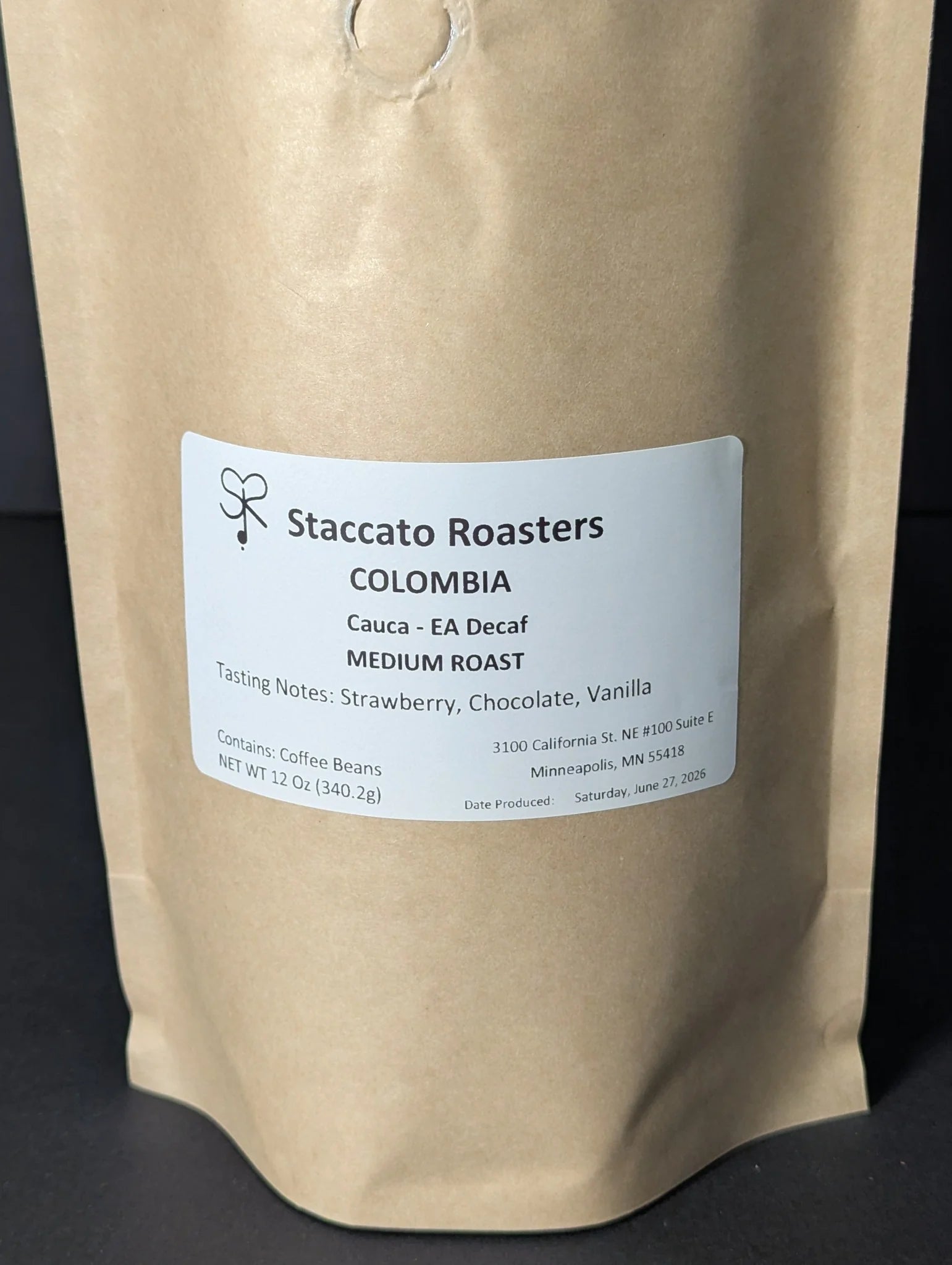 Staccato Roasters Colombia EA Decaf medium roast whole bean coffee, 12 oz bag with strawberry, chocolate, and vanilla tasting notes.