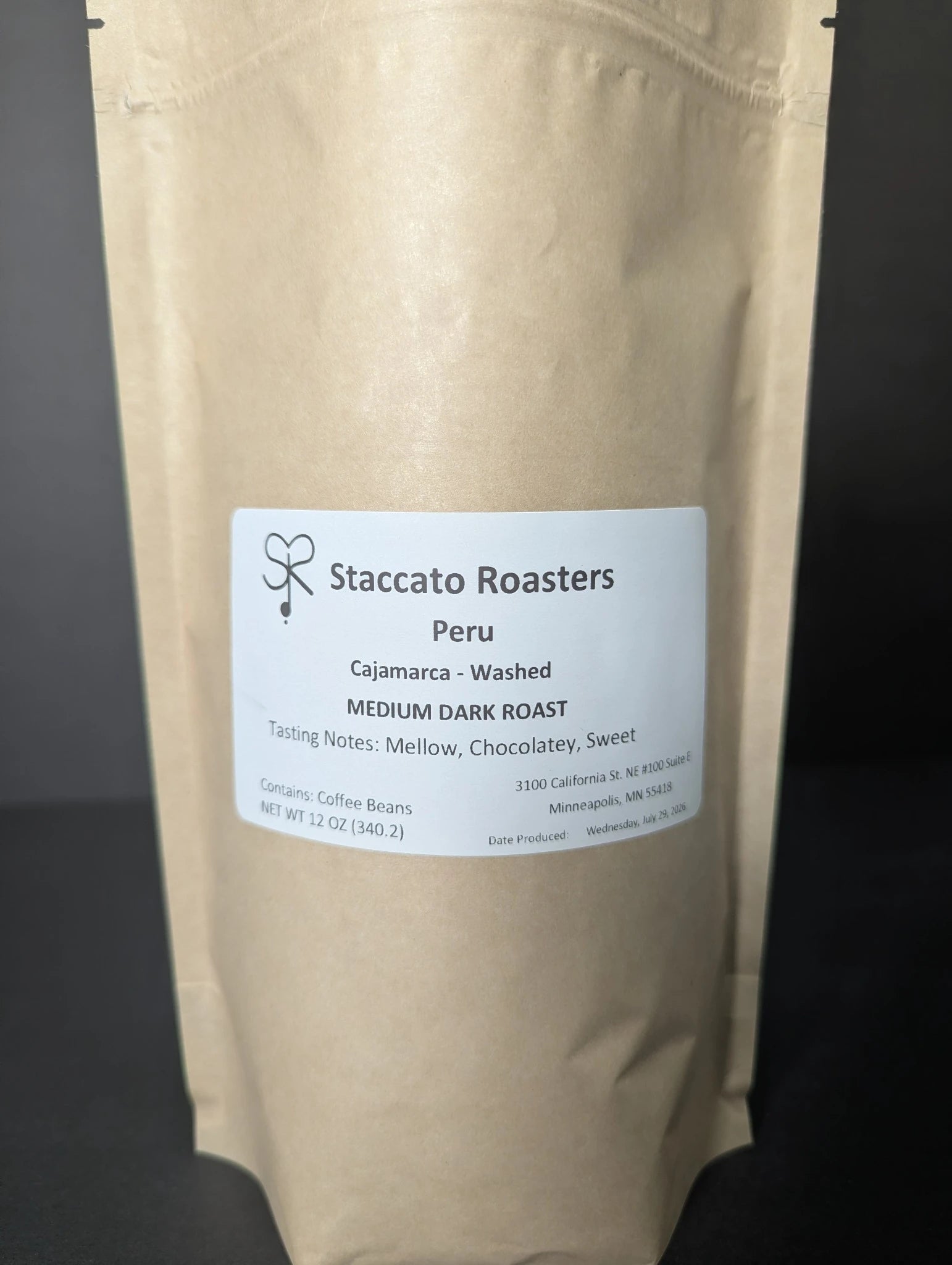 Fresh roasted Staccato Roasters Peru Cajamarca medium dark roast whole bean coffee in a 12 oz kraft coffee bag.